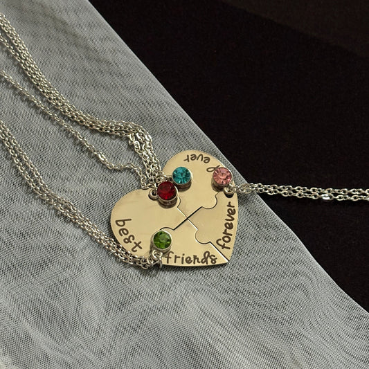 Necklace with a heart-shaped pendant and engraved text on a textured surface