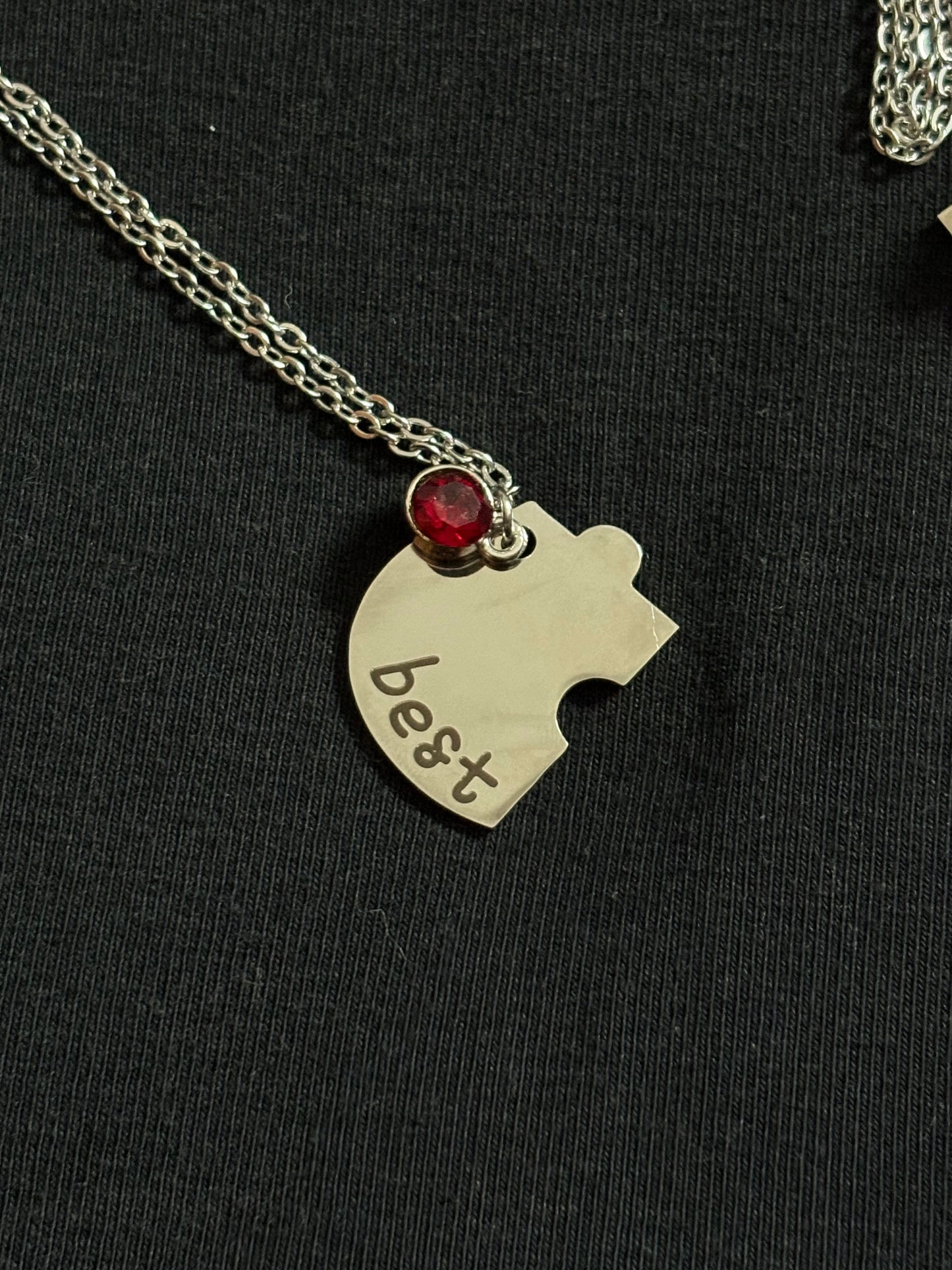 Jewelry piece with 'best' engraved on a black background