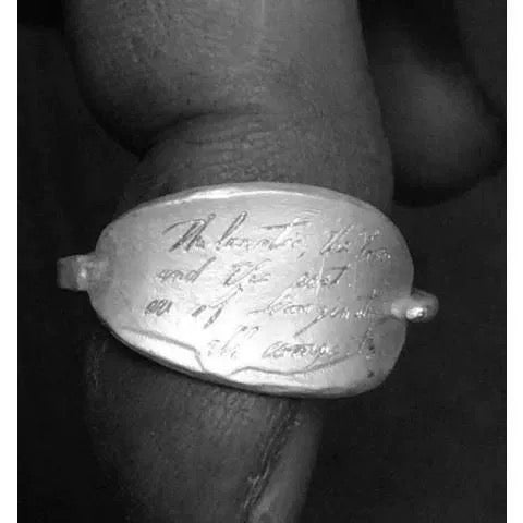 Silver ring with engraved text on a finger giftlove