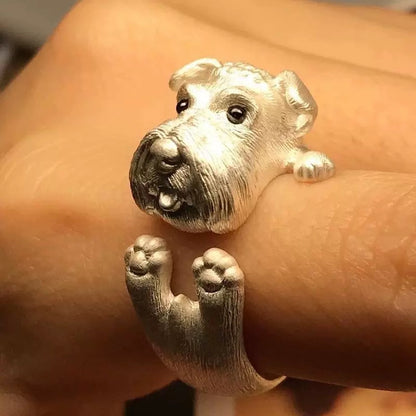 Silver dog-shaped ring on a person's finger